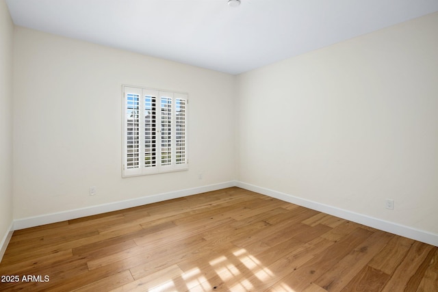 spare room with light hardwood / wood-style flooring