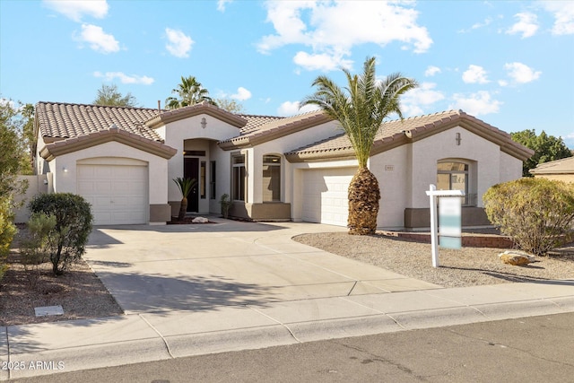 mediterranean / spanish-style home featuring a garage, a tile roof, driveway, and stucco siding