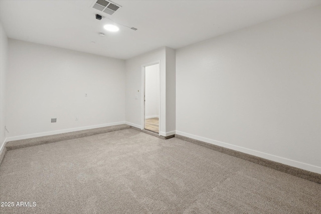 carpeted empty room featuring visible vents and baseboards