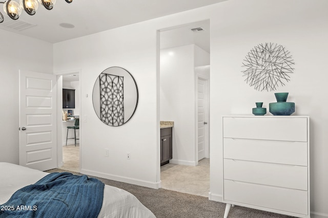 1342 W Hess Ave, Coolidge, AZ 85128 - bedroom with light carpet, baseboards, and a chandelier