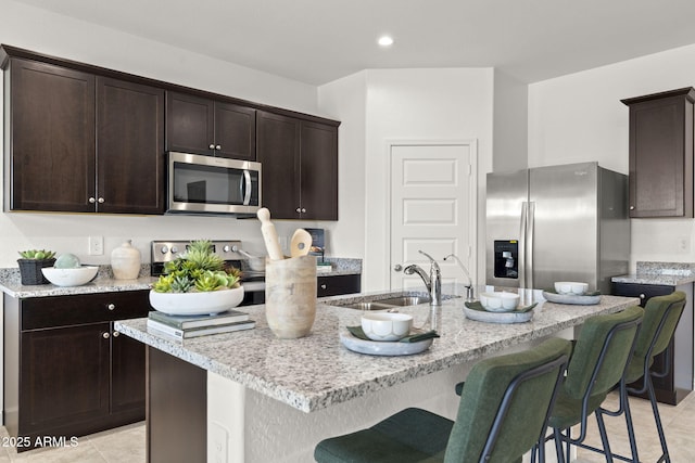1342 W Hess Ave, Coolidge, AZ 85128 - kitchen with stainless steel appliances, a sink, light tile patterned floors, dark brown cabinets, and recessed lighting