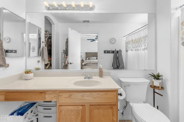 bathroom featuring ceiling fan, vanity, and toilet