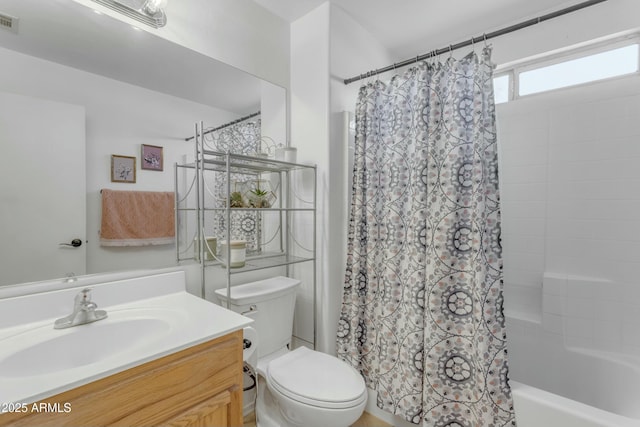 full bathroom with shower / tub combo with curtain, vanity, and toilet