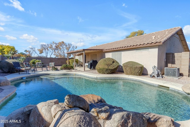 view of swimming pool featuring a patio area, central air condition unit, and a grill