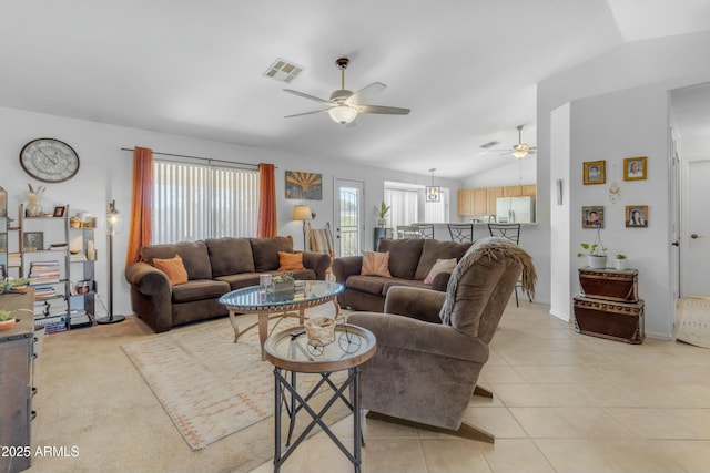 tiled living room featuring ceiling fan and vaulted ceiling