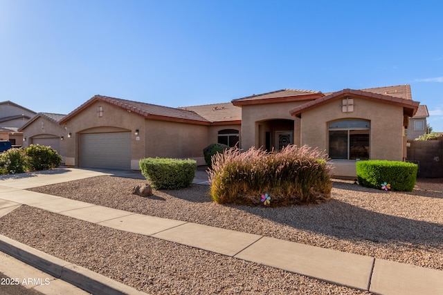 5314 W Bowker St, Laveen, AZ 85339 - mediterranean / spanish house with stucco siding, an attached garage, driveway, and a tiled roof
