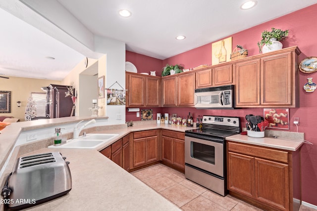 5314 W Bowker St, Laveen, AZ 85339 - kitchen with appliances with stainless steel finishes, light countertops, light tile patterned floors, recessed lighting, and brown cabinets