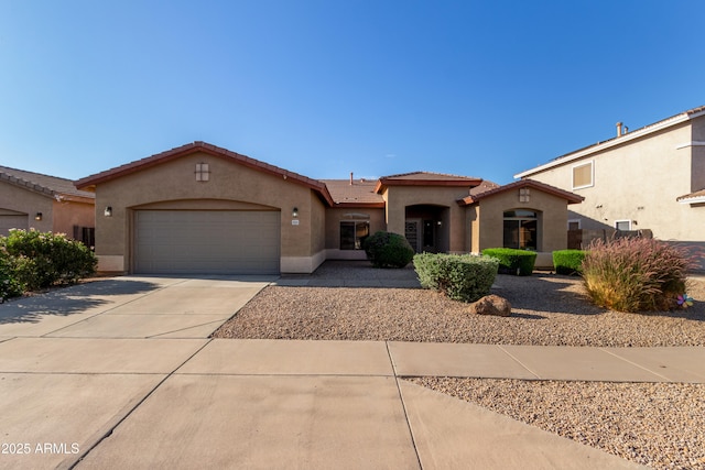 5314 W Bowker St, Laveen, AZ 85339 - mediterranean / spanish-style home with stucco siding, a garage, driveway, and a tiled roof