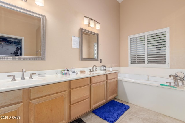 full bath with a sink, tile patterned floors, a garden tub, and double vanity