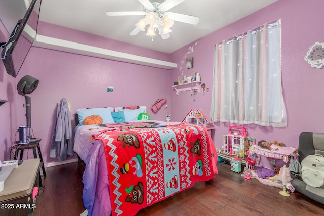 bedroom with a ceiling fan and wood finished floors