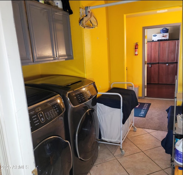 washroom featuring cabinet space, independent washer and dryer, light tile patterned flooring, and light carpet