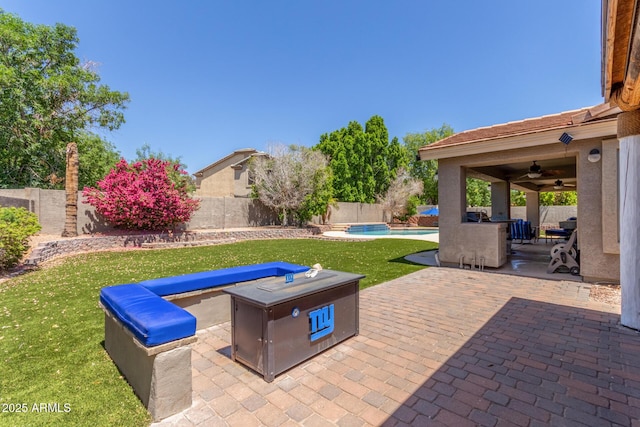 view of patio with a fenced backyard, a fenced in pool, and ceiling fan