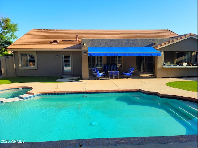 view of swimming pool featuring a patio and a pool with connected hot tub