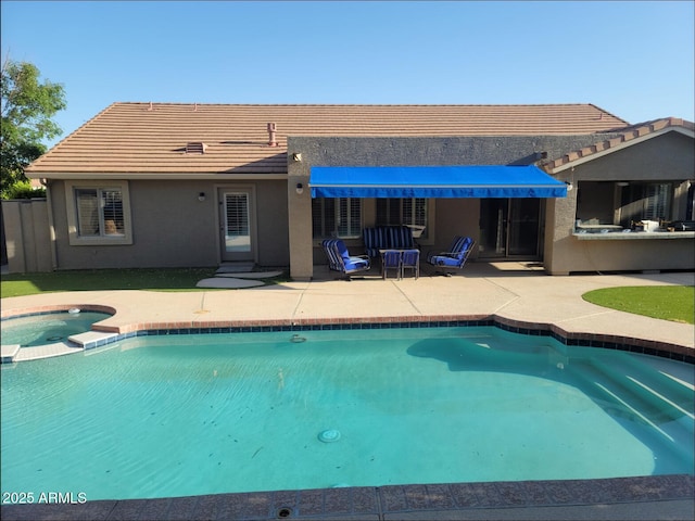 view of swimming pool with a patio area and a pool with connected hot tub