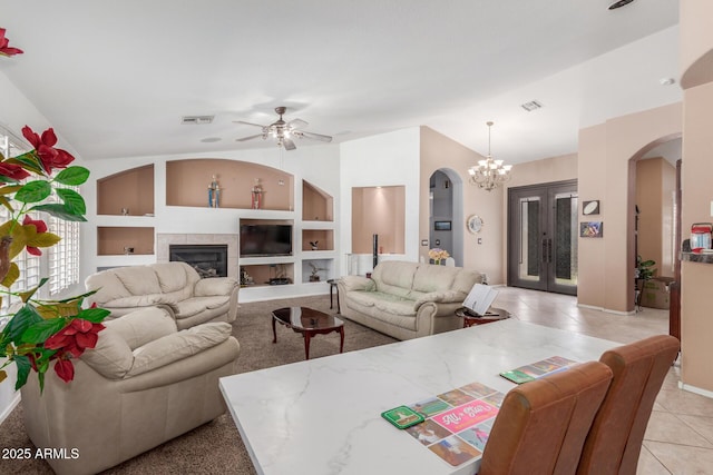 living room with visible vents, arched walkways, ceiling fan with notable chandelier, and lofted ceiling