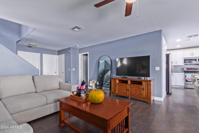 living room featuring dark hardwood / wood-style flooring and ceiling fan