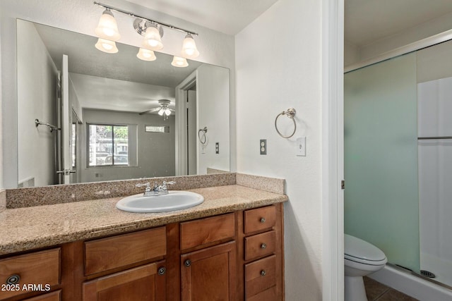 full bath with ceiling fan, tile patterned flooring, vanity, toilet, and a stall shower