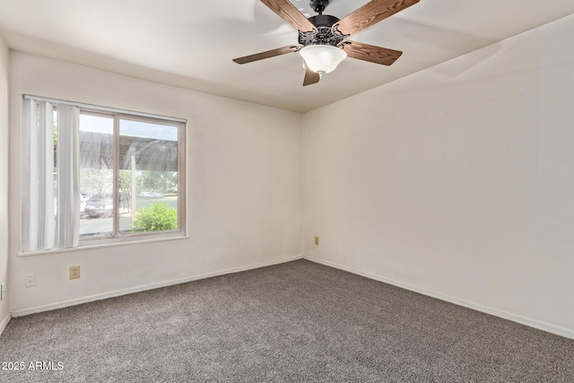 carpeted empty room with baseboards and ceiling fan