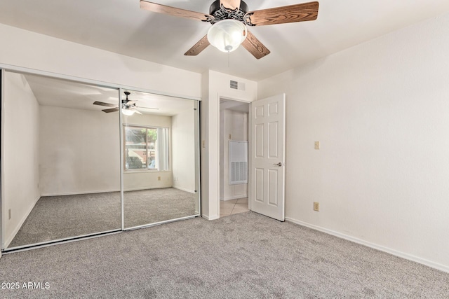 unfurnished bedroom with visible vents, a ceiling fan, a closet, baseboards, and carpet flooring
