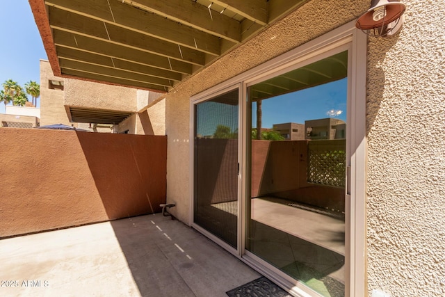 view of patio featuring fence