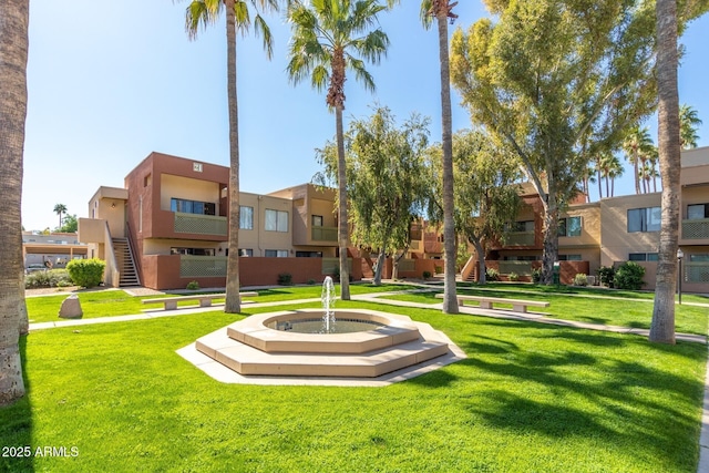 view of property's community featuring a lawn and a residential view