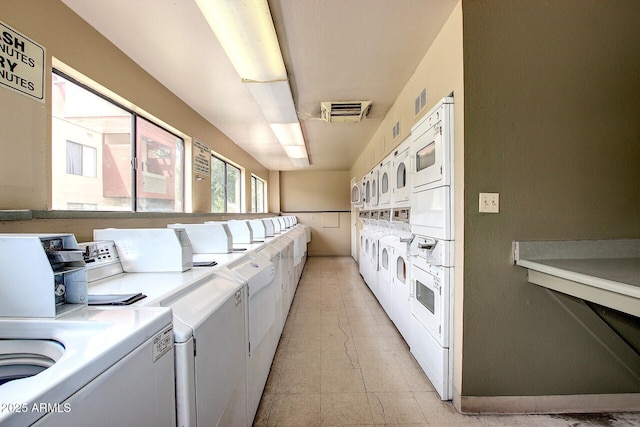 shared laundry area featuring visible vents, stacked washer and dryer, and washing machine and dryer