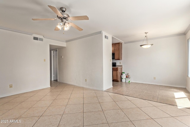 unfurnished room with light tile patterned floors, ornamental molding, a ceiling fan, and visible vents
