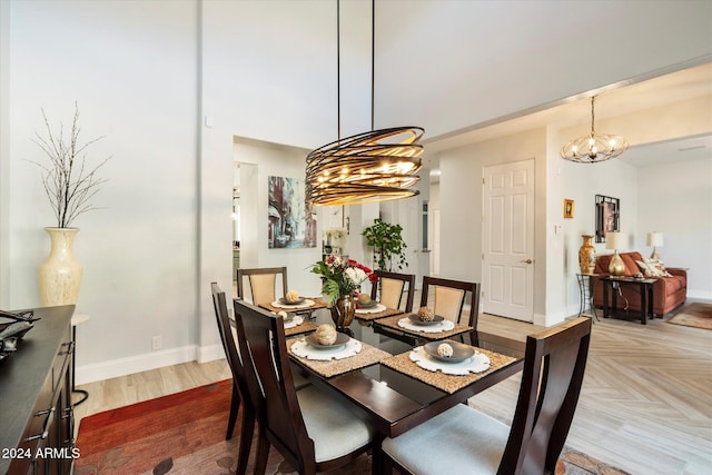 dining area with hardwood / wood-style flooring and a notable chandelier