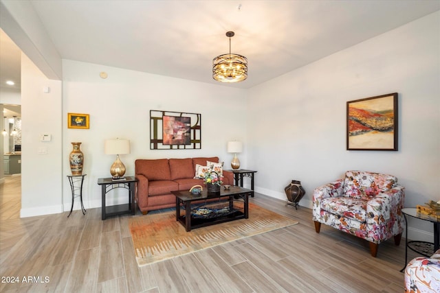 living room featuring light hardwood / wood-style floors and a notable chandelier