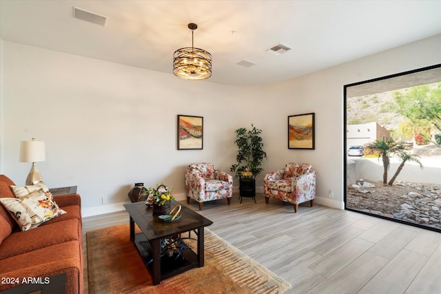 living room featuring hardwood / wood-style flooring and a chandelier