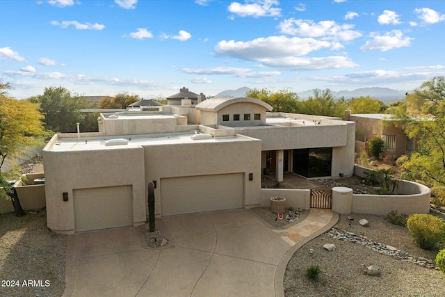 pueblo revival-style home with a mountain view and a garage