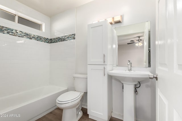 bathroom featuring hardwood / wood-style floors, tiled shower / bath combo, toilet, and ceiling fan