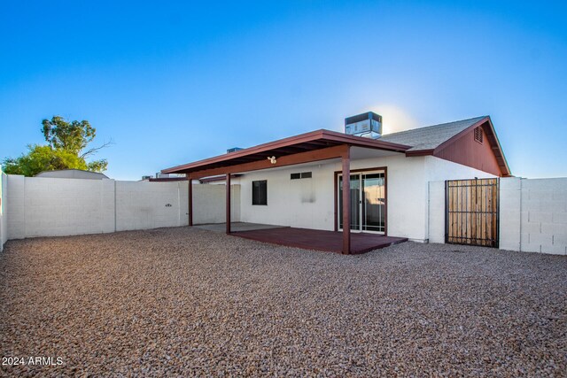 back of property featuring central AC unit and a patio area