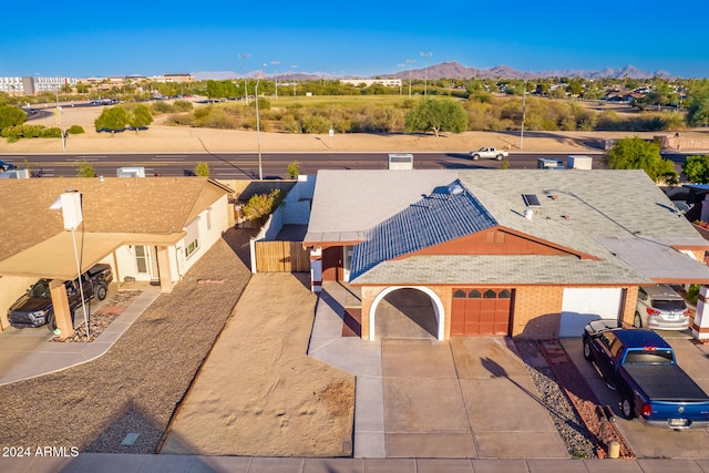 view of front facade with a mountain view and a garage