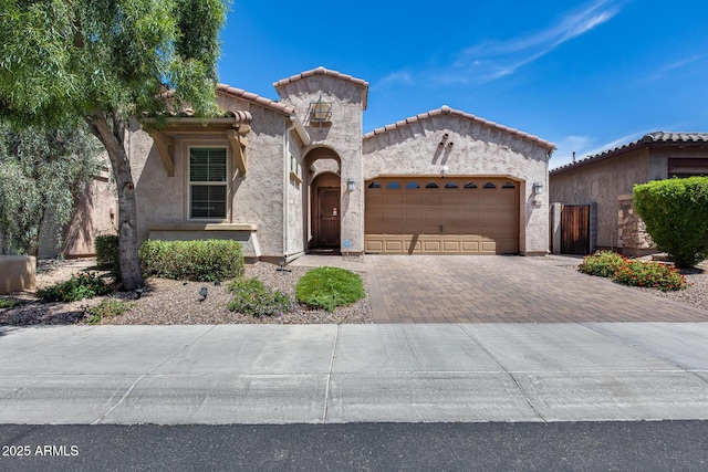 4630 E Navigator Ln, Phoenix, AZ 85050 - mediterranean / spanish-style home featuring an attached garage, decorative driveway, a tile roof, and stucco siding