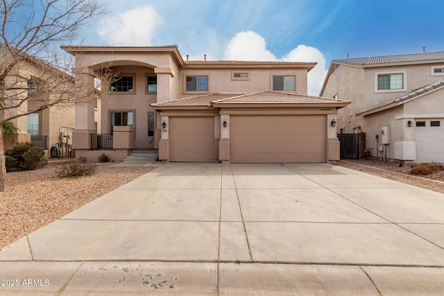 view of front of house with a garage, driveway, a tiled roof, and stucco siding