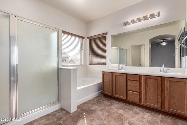 full bath with double vanity, a stall shower, a sink, and a bath