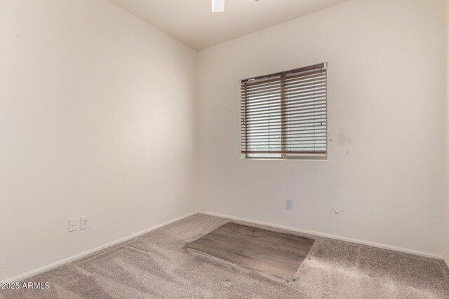 spare room with carpet floors and baseboards