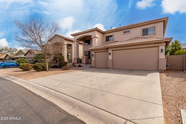 view of front of home featuring concrete driveway, an attached garage, and stucco siding