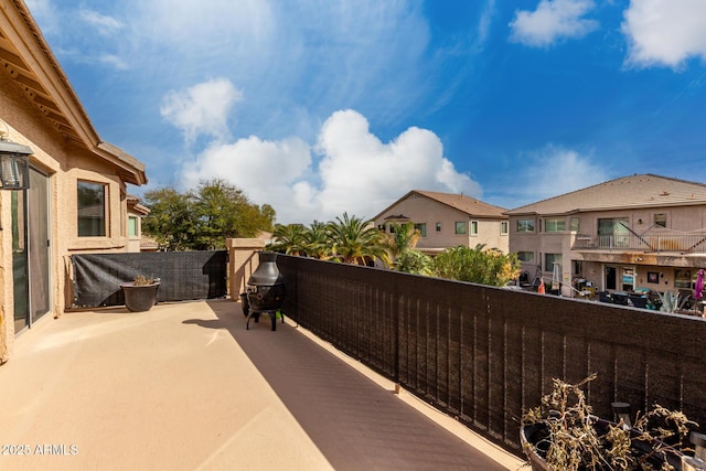 view of patio with a residential view and a balcony