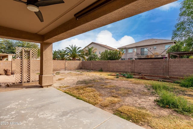 view of yard with ceiling fan, a fenced backyard, and a patio