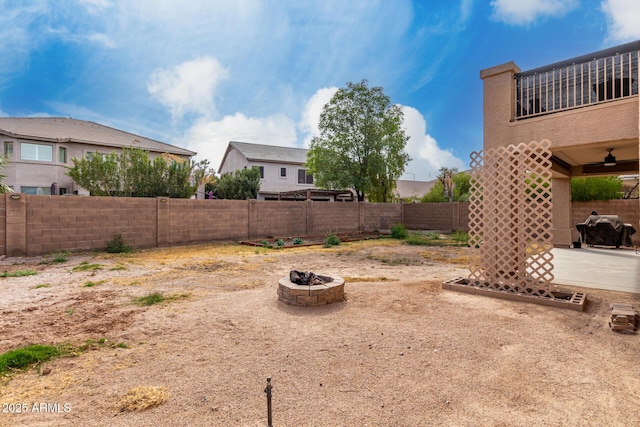 view of yard featuring a patio, an outdoor fire pit, and a fenced backyard