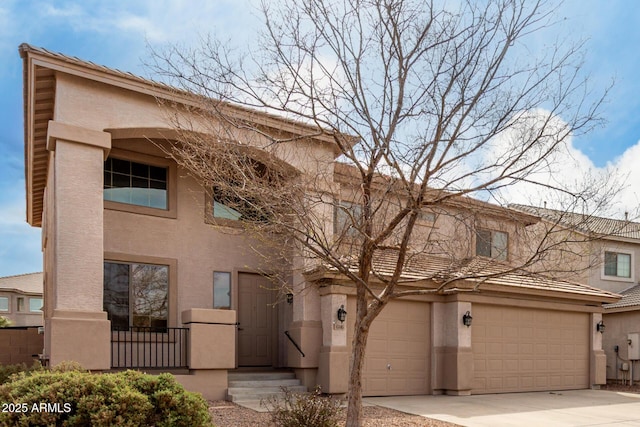 view of front of property featuring concrete driveway and stucco siding