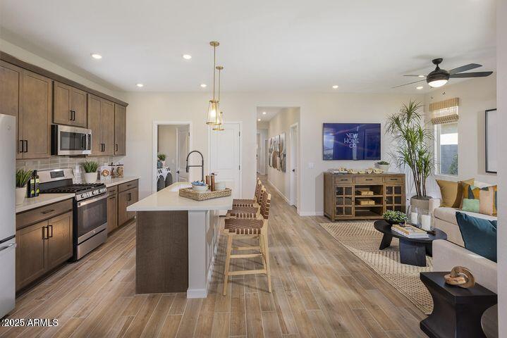 20724 N 224th Ave, Surprise, AZ 85387 - kitchen featuring appliances with stainless steel finishes, light countertops, a ceiling fan, open floor plan, and recessed lighting
