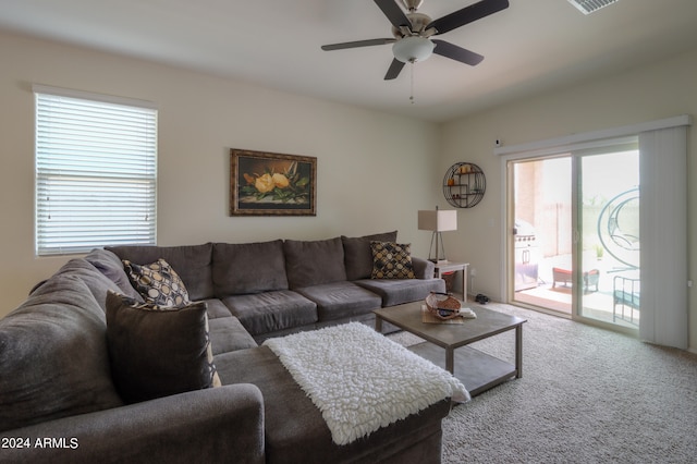 living room featuring carpet and ceiling fan