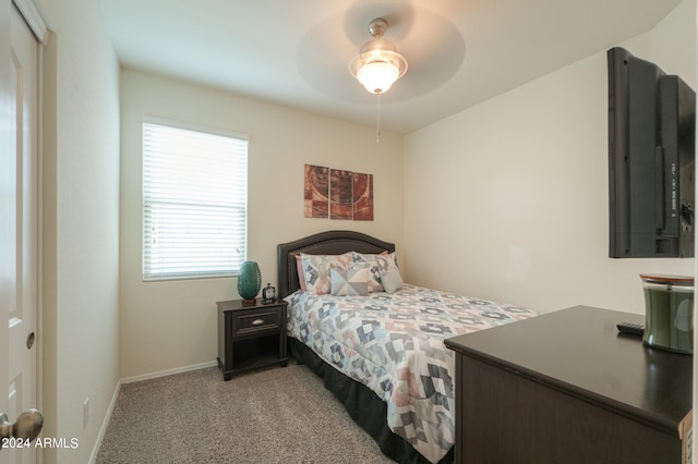 carpeted bedroom featuring ceiling fan and a closet