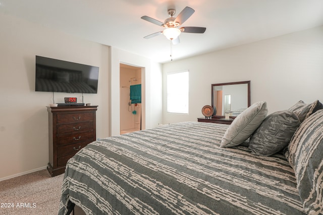 carpeted bedroom with ceiling fan and ensuite bathroom