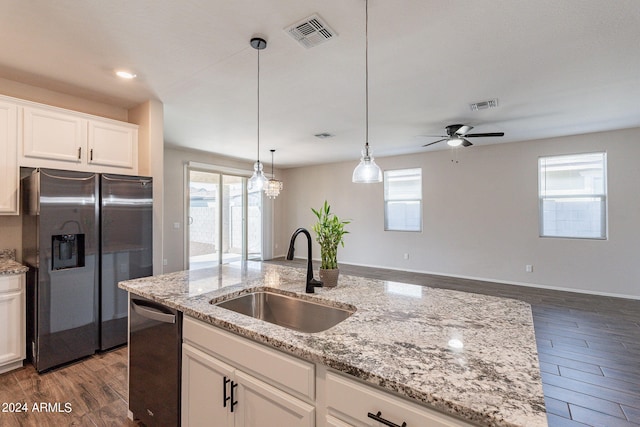 kitchen with stainless steel appliances, sink, dark hardwood / wood-style flooring, and white cabinetry