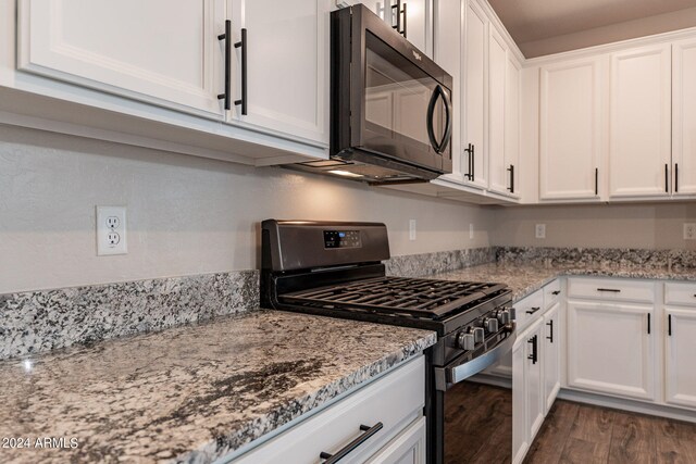 kitchen featuring light stone countertops, black appliances, dark hardwood / wood-style floors, and white cabinets