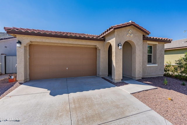 mediterranean / spanish-style house featuring a garage